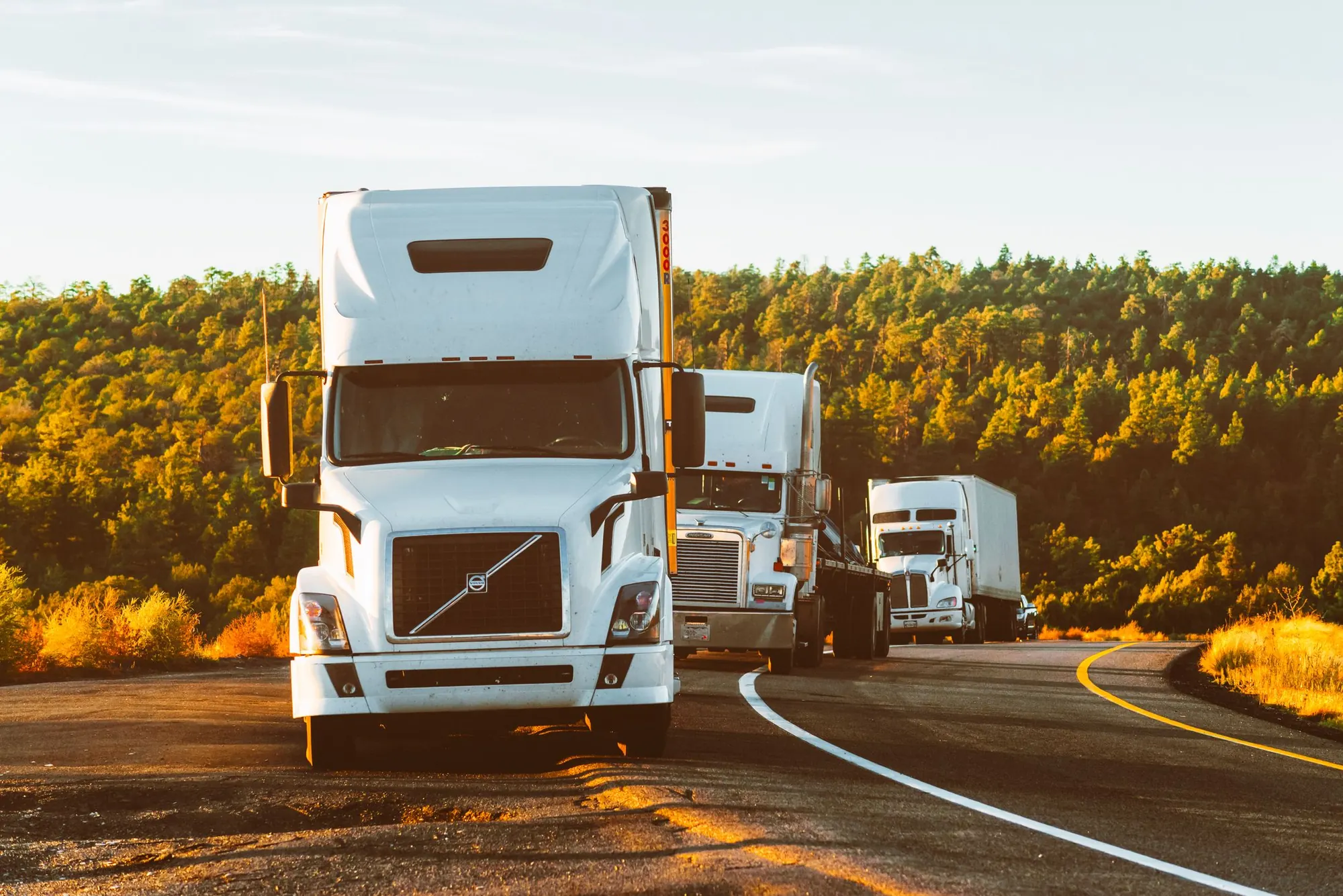 Freight trucks travelling together on a New York highway